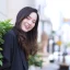 portrait-asian-woman-with-long-hair-wears-black-coat-stands-outdoor-town